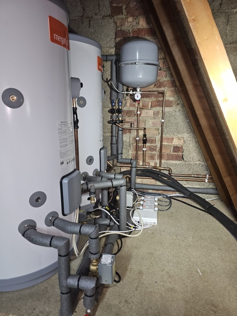 Twin Megaflo unvented hot water cylinders with insulated pipework installed by APS