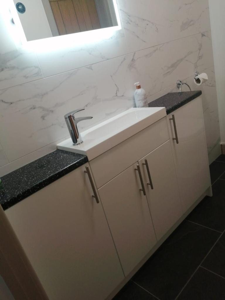 Modern bathroom vanity with sink and chrome tap installed by APS Plumbing